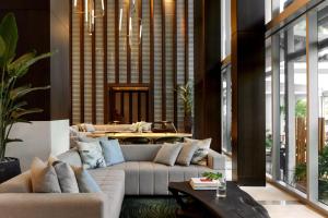 a living room with couches and a table at Kimpton EPIC Hotel, an IHG Hotel in Miami
