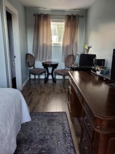 a bedroom with a bed and a dresser with a tv at Town and Country Motel in Nipigon