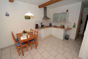 a kitchen with a table and chairs and a kitchen with a counter at Hof Brinker - Kornspeicher in Boiensdorf +37 photos