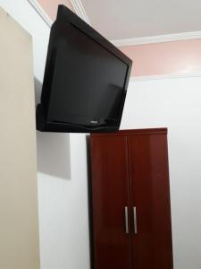 a flat screen tv sitting on top of a cabinet at Unihotel in Hortolândia