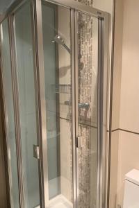 a shower with a glass door in a bathroom at Forever FOZ in Foz +30 photos