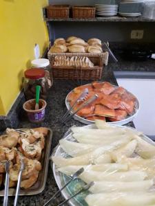 a counter top with plates of food on it at Unihotel in Hortolândia