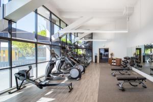 a gym with treadmills and elliptical machines at The Domain Hotel in Sunnyvale