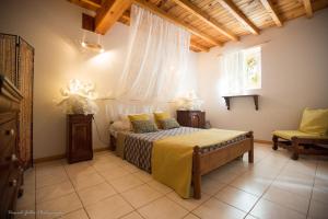 a bedroom with a bed and a window and a chair at Domaine de Beaufort in Saint-Front-de-Pradoux +42 photos