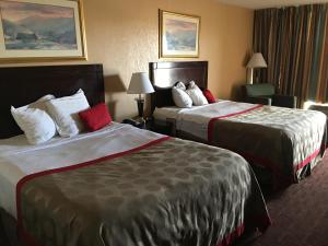 a hotel room with two beds in a room at Budget Inn Laramie in Laramie