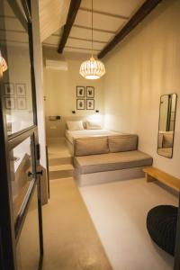 a bedroom with two beds and a chandelier at Pyli Apartments in Pylos