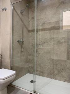 a bathroom with a shower and a toilet at UIM Mediterraneo PB Aragon B Wifi in Puerto de Sagunto