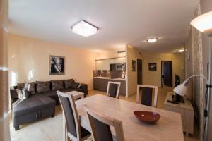 a living room with a table and a couch at Just Apartments in Wrocław