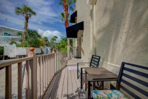a patio area with chairs, tables, and umbrellas at The Ringling Beach House in Siesta Key