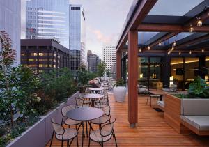 a balcony with tables and chairs on a building at Little National Hotel Sydney in Sydney