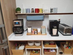 a kitchen with a coffee maker on a shelf at Pensión Araba II in Vitoria-Gasteiz