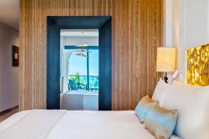 a bedroom with a bed and a view of the ocean at Sanctuary Cap Cana, a Luxury Collection All-Inclusive Resort, Dominican Republic in Punta Cana