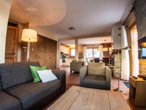 a living room with a couch and two chairs at Luxurious chalet near the pistes in family-friendly St François Longchamp in Saint-François-Longchamp