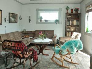 a living room with a couch and a table at 11 person holiday home in Syvde in Myklebost