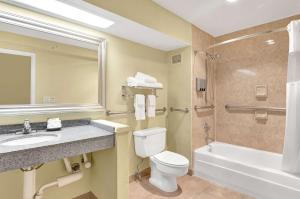 a bathroom with a toilet and a sink and a shower at Hotel Nexus; BW Signature Collection in Seattle