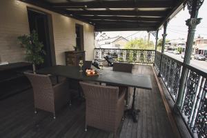 a balcony with a table and chairs on a deck at William Arnott Boutique Accommodation in Morpeth