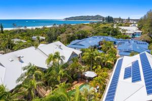 an aerial view of a resort with palm trees and the ocean at Mariner Bay Apartments in Byron Bay