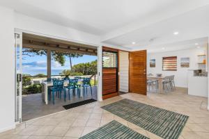 a kitchen and dining room with sliding glass doors to a balcony at Beachies 1 in Point Lookout