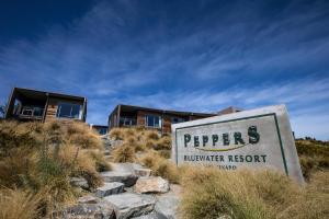 a sign in front of a building on a hill at Peppers Bluewater Resort in Lake Tekapo