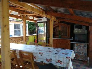a kitchen with a large table in a room at Hostel Pascalis Alesd in Aleşd