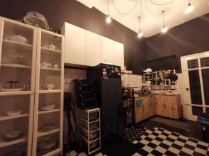 a kitchen with a black refrigerator and a checkered floor at 5M cozy Homestay Bukit Mahkota Kajang in Kajang