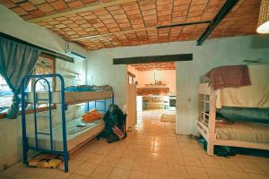 a room with bunk beds and a room with a hallway at Blue Pepper Beds Sayulita in Sayulita