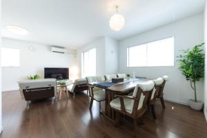 a dining room with a table and chairs at The Beachfront House ビーチフロントの一軒家 4名迄 in Miura