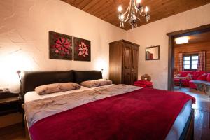 a bedroom with a large bed with a red blanket at Apartment HOT CHILI in Hermagor