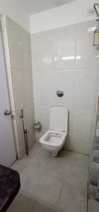 a bathroom with a toilet in a stall at La Riviera Suites in Hyderabad