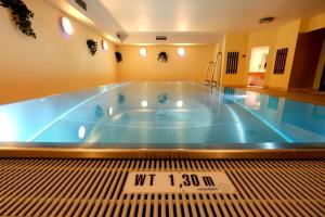 a large swimming pool with a sign in the middle at Apartment HOT CHILI - Nassfeld in Hermagor