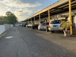 
a parking lot filled with parked cars and trucks at Top 1 Motel in Rockhampton
