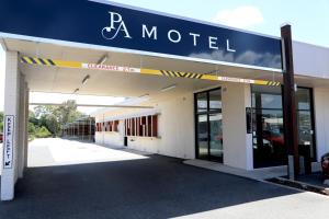 a car dealership with a sign on the side of it at Park Avenue Hotel Motel in Rockhampton