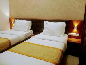 Postel nebo postele na pokoji v ubytování Hotel Laxmi Cityside