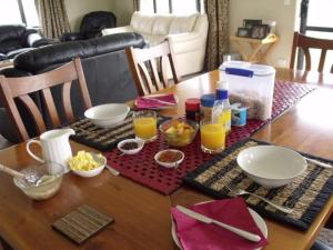 a table with breakfast foods and drinks on it at BigSky Bed and Breakfast in Omarama