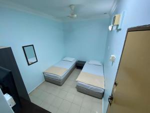 Postel nebo postele na pokoji v ubytování Hotel Permai Melaka Raya