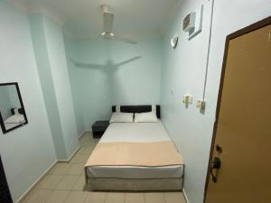 Postel nebo postele na pokoji v ubytování Hotel Permai Melaka Raya