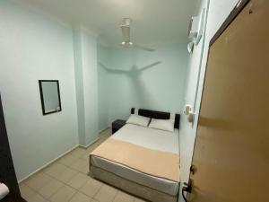 Postel nebo postele na pokoji v ubytování Hotel Permai Melaka Raya