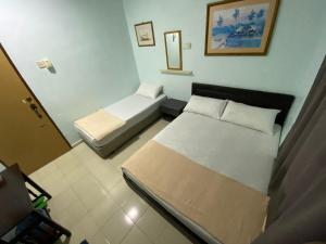 Postel nebo postele na pokoji v ubytování Hotel Permai Melaka Raya