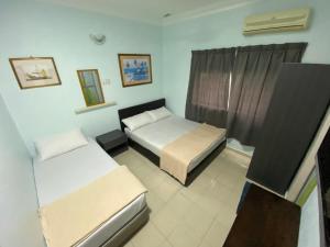 Postel nebo postele na pokoji v ubytování Hotel Permai Melaka Raya