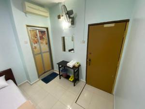Postel nebo postele na pokoji v ubytování Hotel Permai Melaka Raya