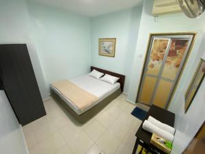 Postel nebo postele na pokoji v ubytování Hotel Permai Melaka Raya