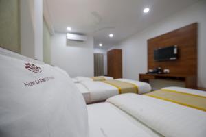 Postel nebo postele na pokoji v ubytování Hotel Laxmi Cityside