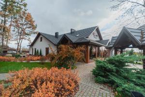 a white house with a black roof at Turiyske Podvir'ya in Blazhennik