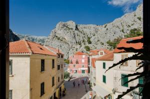 a view of a street in a town with mountains in the background at Inn by the River in Omiš