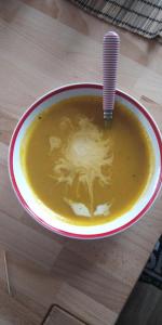 a bowl of soup with a straw in it on a table at U Broučků in Lipova Lazne