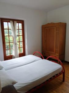 a bedroom with a bed and a dresser and a window at Fenecchio in Fiumalbo