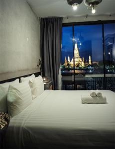 a hotel room with a large window overlooking a city at Inn a day in Bangkok