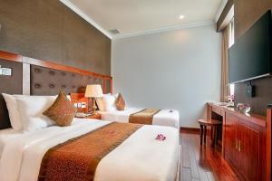 Giường trong phòng chung tại Samdi Da Nang Central Hotel