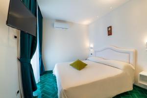 Ein Bett oder Betten in einem Zimmer der Unterkunft Hotel Villa Pandora