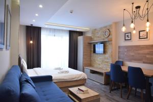 a hotel room with a bed and a dining room at Milmari Apartment 43 Premier Pollo in Kopaonik +29 photos